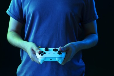 Photo of Man with controller on black background, closeup