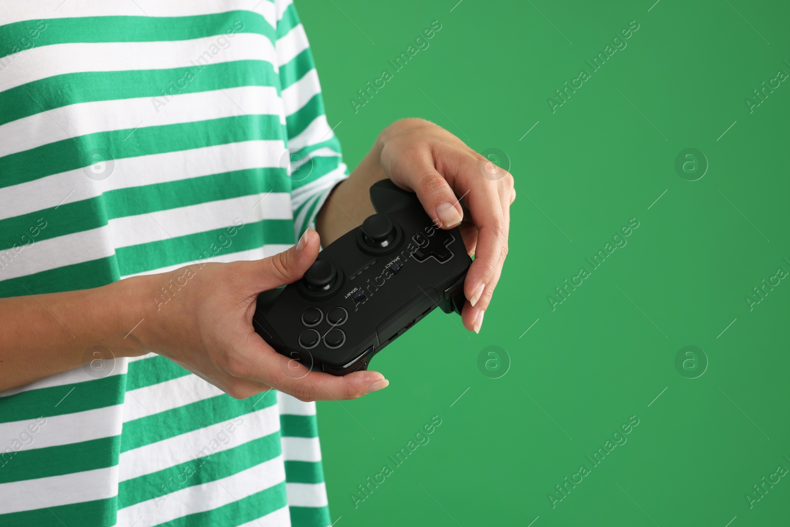 Photo of Woman playing video games with controller on green background, closeup. Space for text