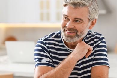 Photo of Portrait of happy middle aged man indoors