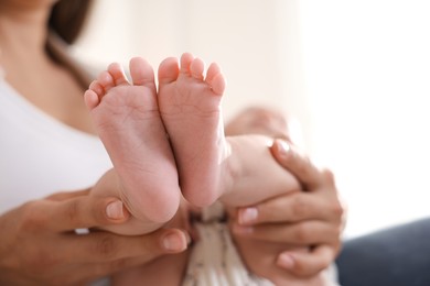 Photo of Mother with her cute little baby at home, closeup