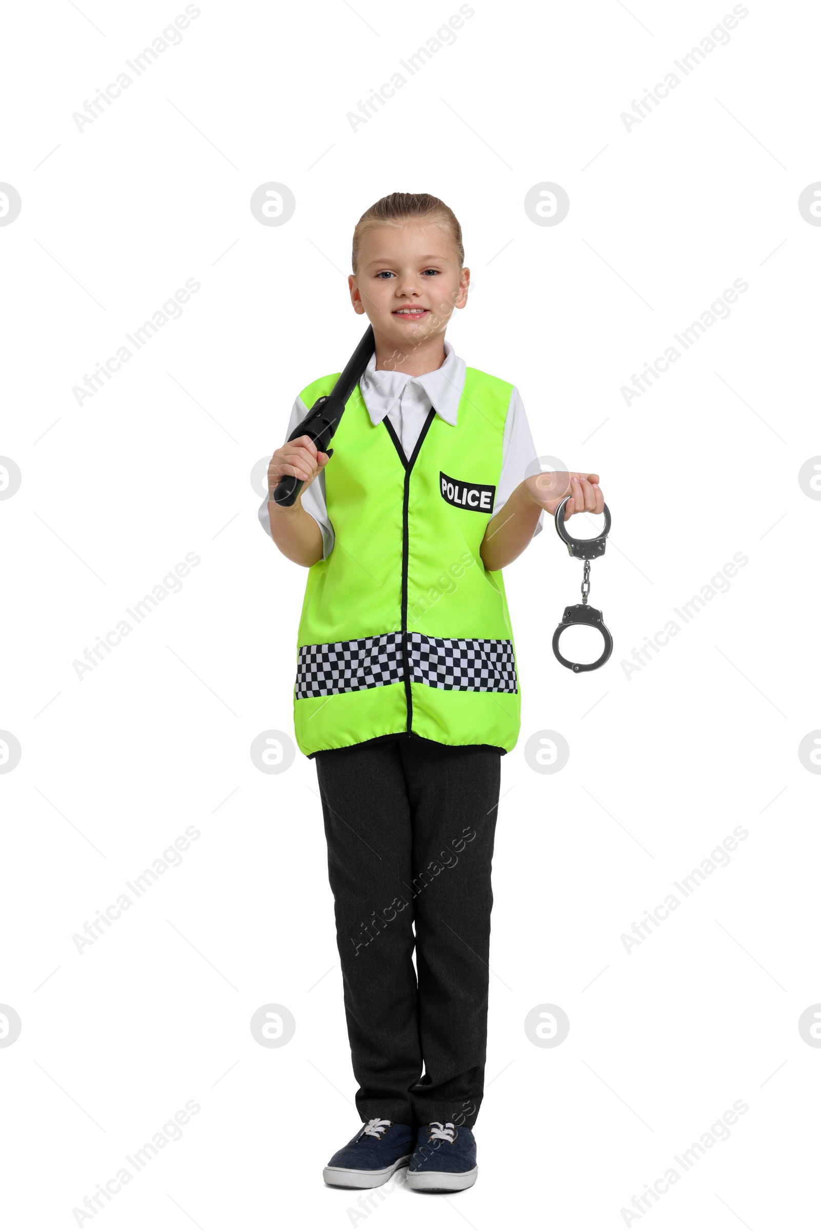 Photo of Little girl with baton and handcuffs pretending to be policewoman on white background. Dreaming of future profession