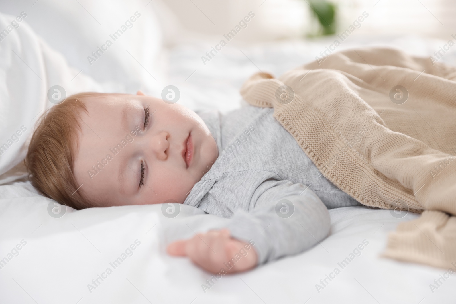 Photo of Cute little baby sleeping on bed at home