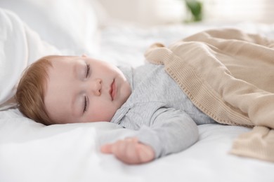 Photo of Cute little baby sleeping on bed at home