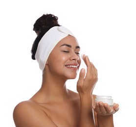 Photo of Beautiful woman applying cream onto face against white background