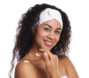 Photo of Beautiful woman applying cream onto shoulder against white background