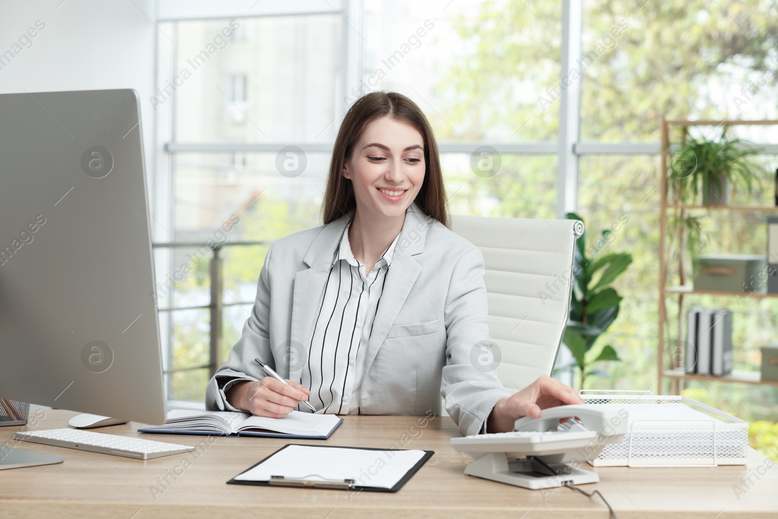 Photo of Banker working at wooden table in office