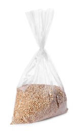 Photo of Plastic bag with wheat grains isolated on white