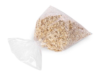 Photo of Plastic bag with oat flakes isolated on white, top view