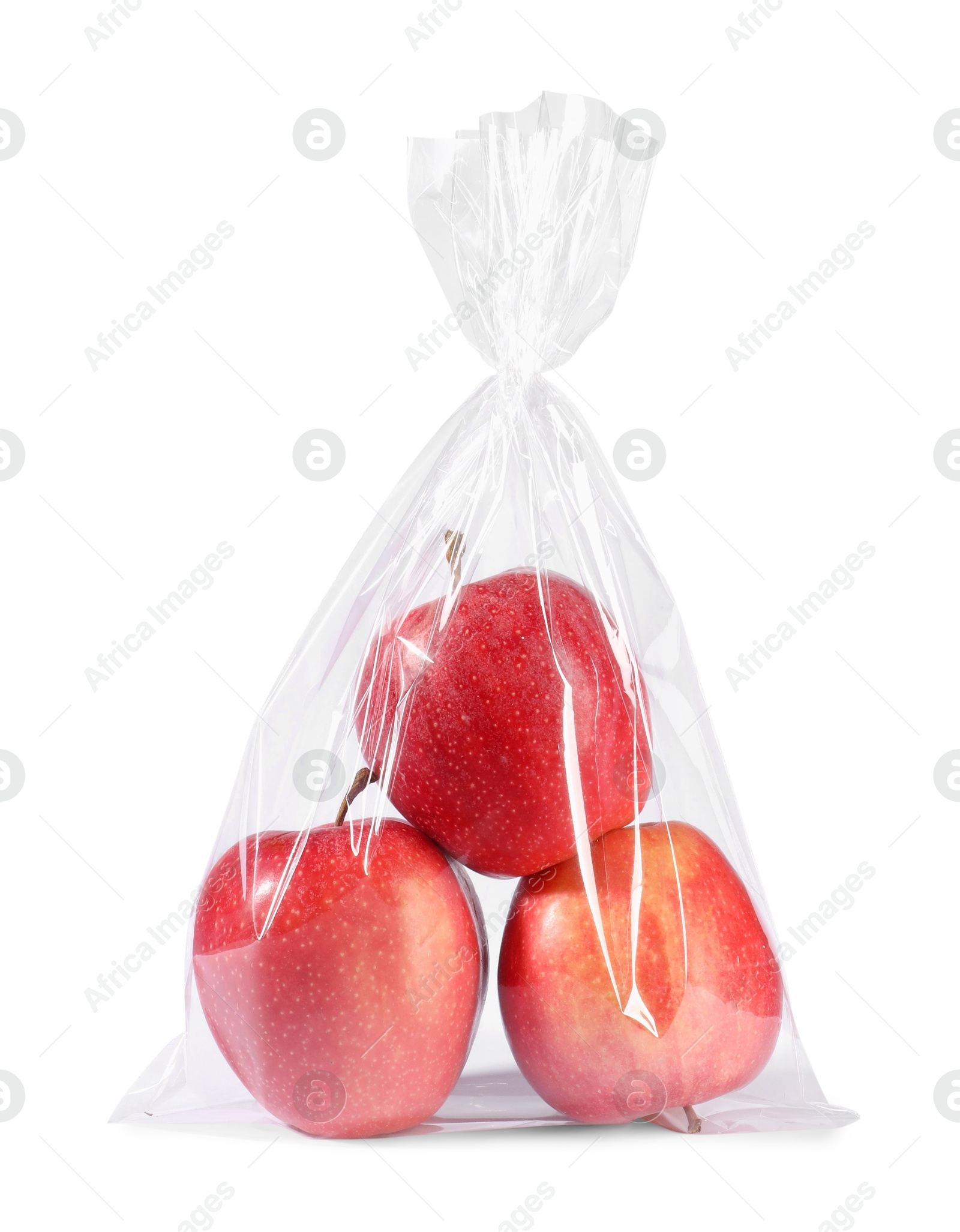 Photo of Plastic bag with red apples isolated on white