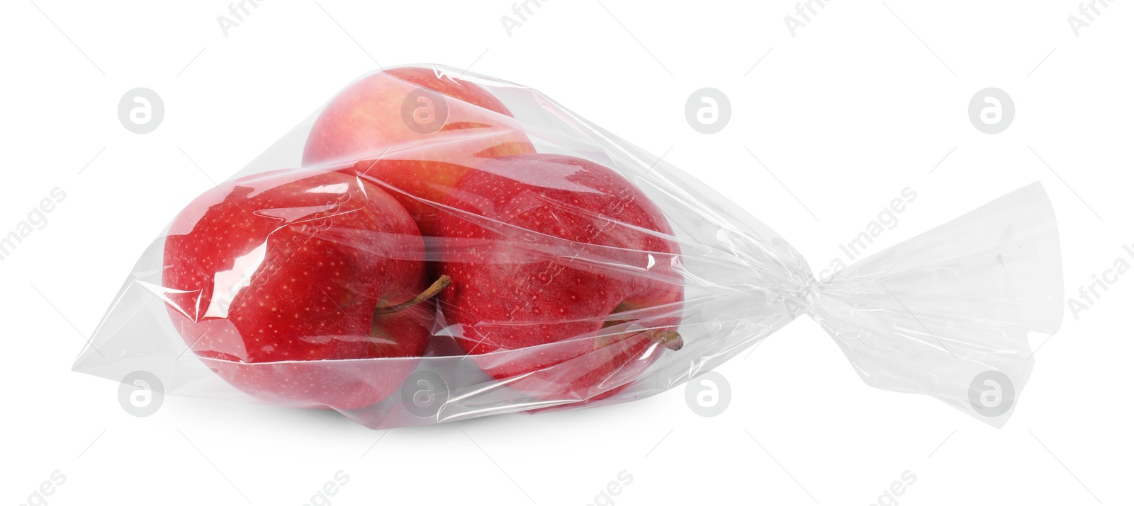 Photo of Plastic bag with red apples isolated on white