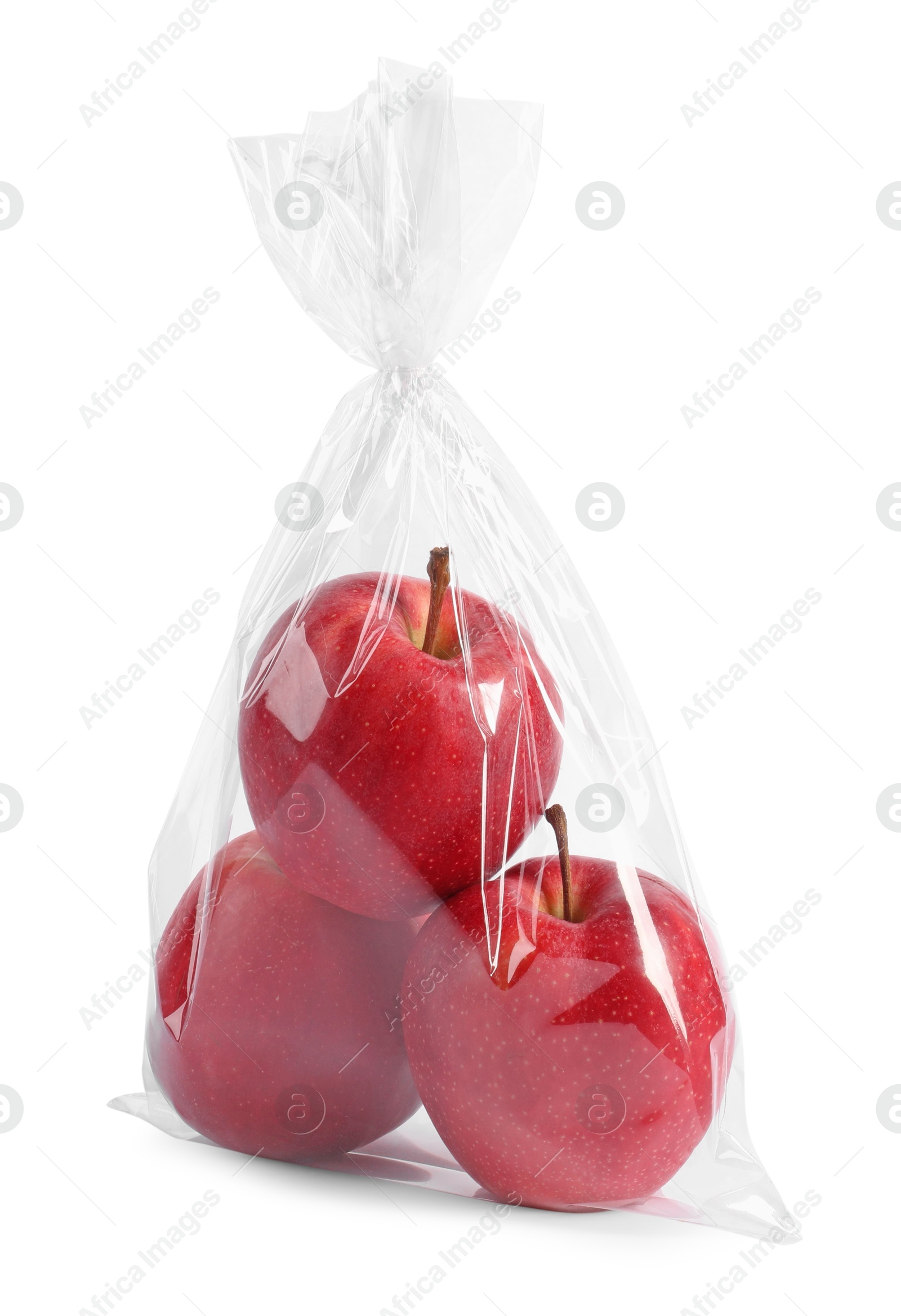 Photo of Plastic bag with red apples isolated on white