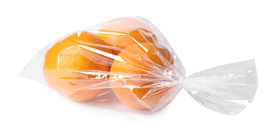 Photo of Plastic bag with fresh oranges isolated on white