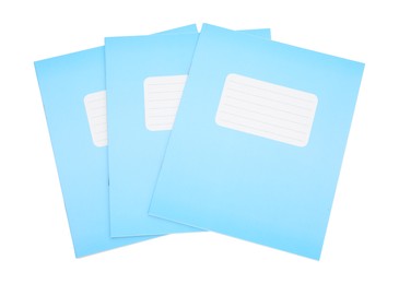 Photo of Blue copybooks isolated on white, top view. School stationery