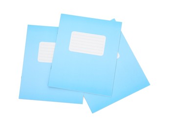 Photo of Blue copybooks isolated on white, top view. School stationery