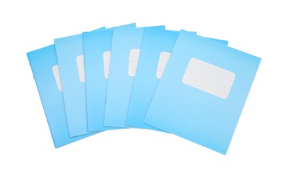 Photo of Blue copybooks isolated on white, top view. School stationery