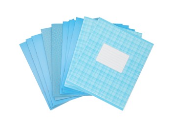 Photo of Blue copybooks isolated on white, top view. School stationery