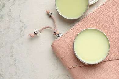 Photo of Natural solid perfume and leather bag on white textured background, flat lay. Space for text