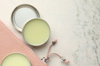 Photo of Natural solid perfume and leather bag on white textured background, flat lay. Space for text