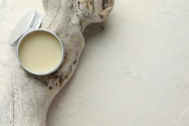 Photo of Natural solid perfume in container and snag on white background, top view. Space for text