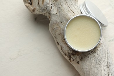 Photo of Natural solid perfume in container and snag on white background, top view. Space for text