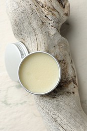 Photo of Natural solid perfume in container and snag on white background, top view