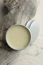 Photo of Natural solid perfume in container and snag on white background, top view