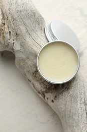 Photo of Natural solid perfume in container and snag on white background, top view