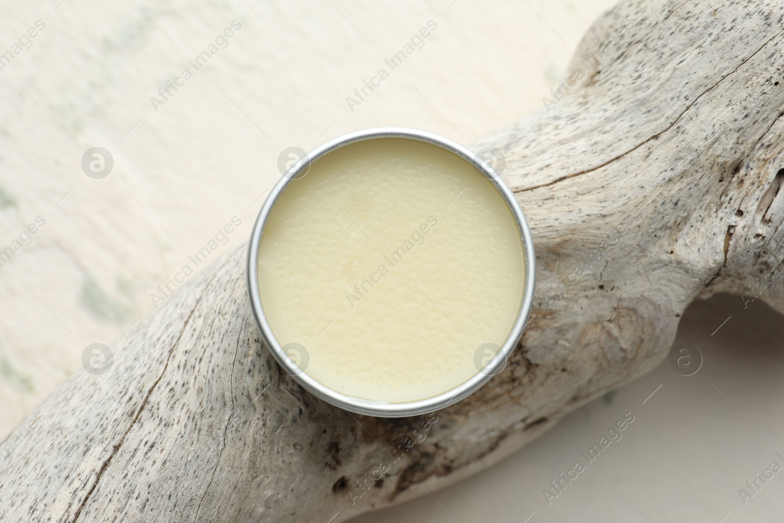 Photo of Natural solid perfume in container and snag on white background, top view