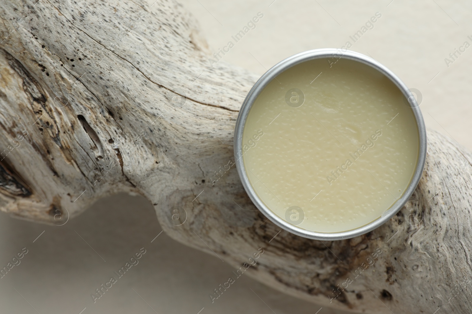 Photo of Natural solid perfume in container and snag on white background, top view