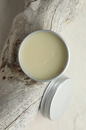 Photo of Natural solid perfume in container and snag on white background, top view