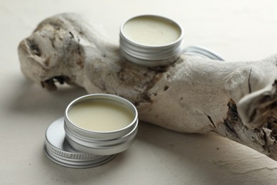 Natural solid perfume and snag on white table, closeup