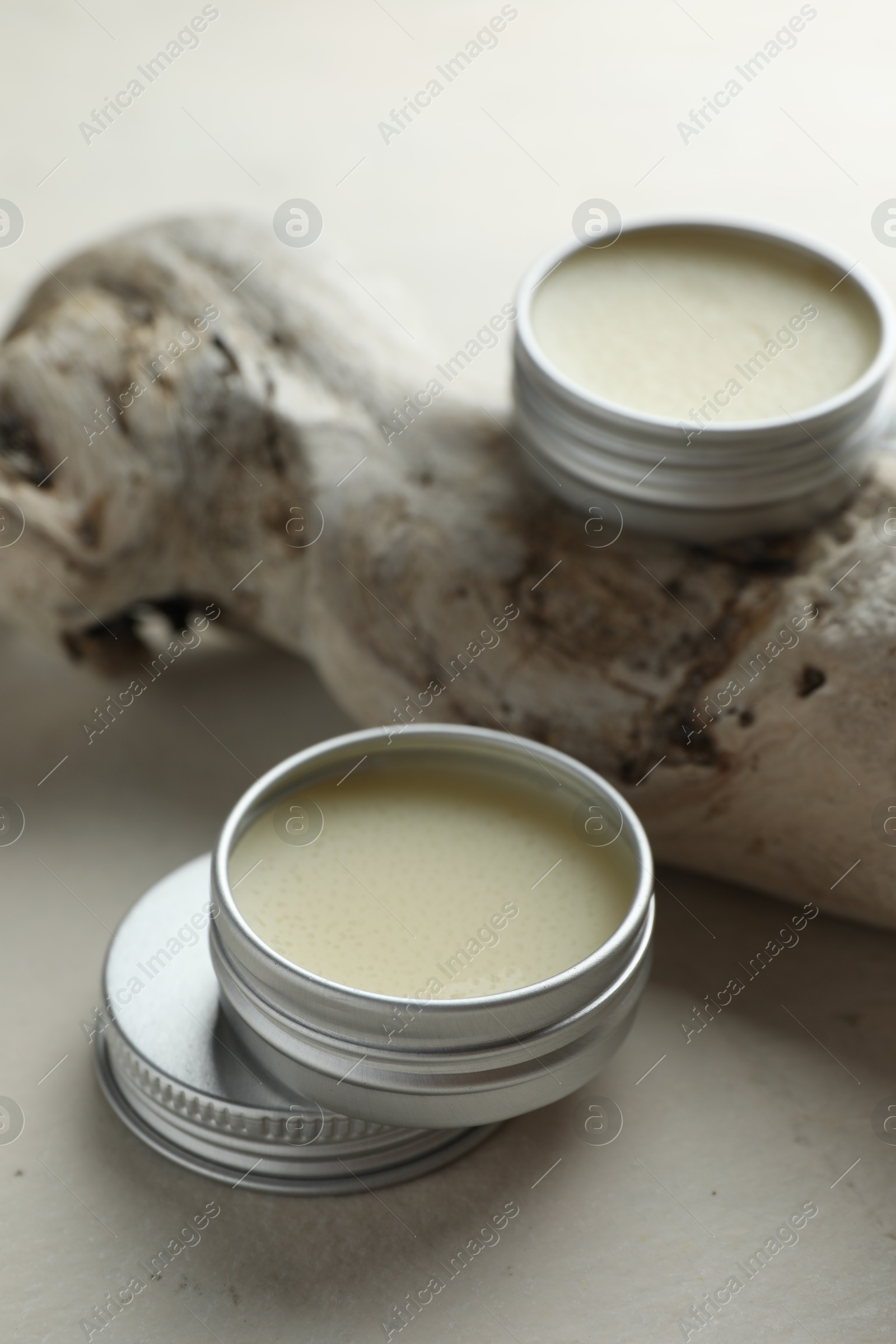 Photo of Natural solid perfume and snag on white table, closeup