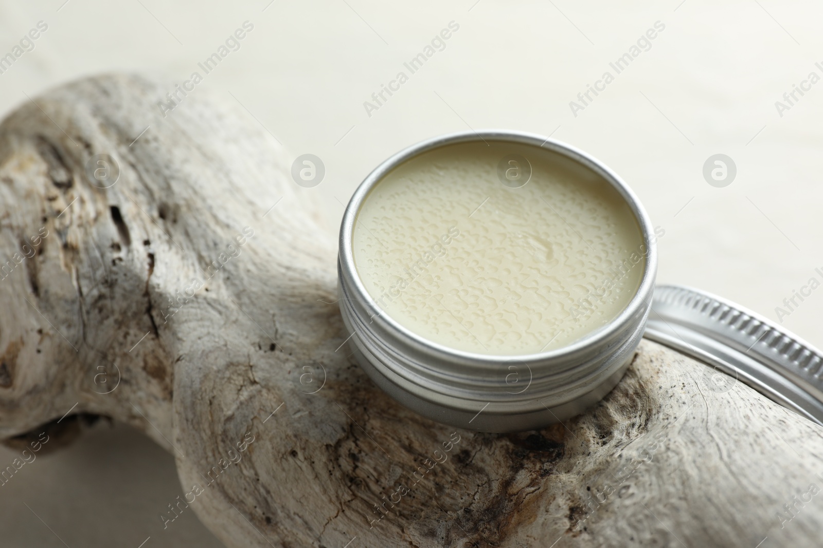 Photo of Natural solid perfume in container and snag on white table, closeup