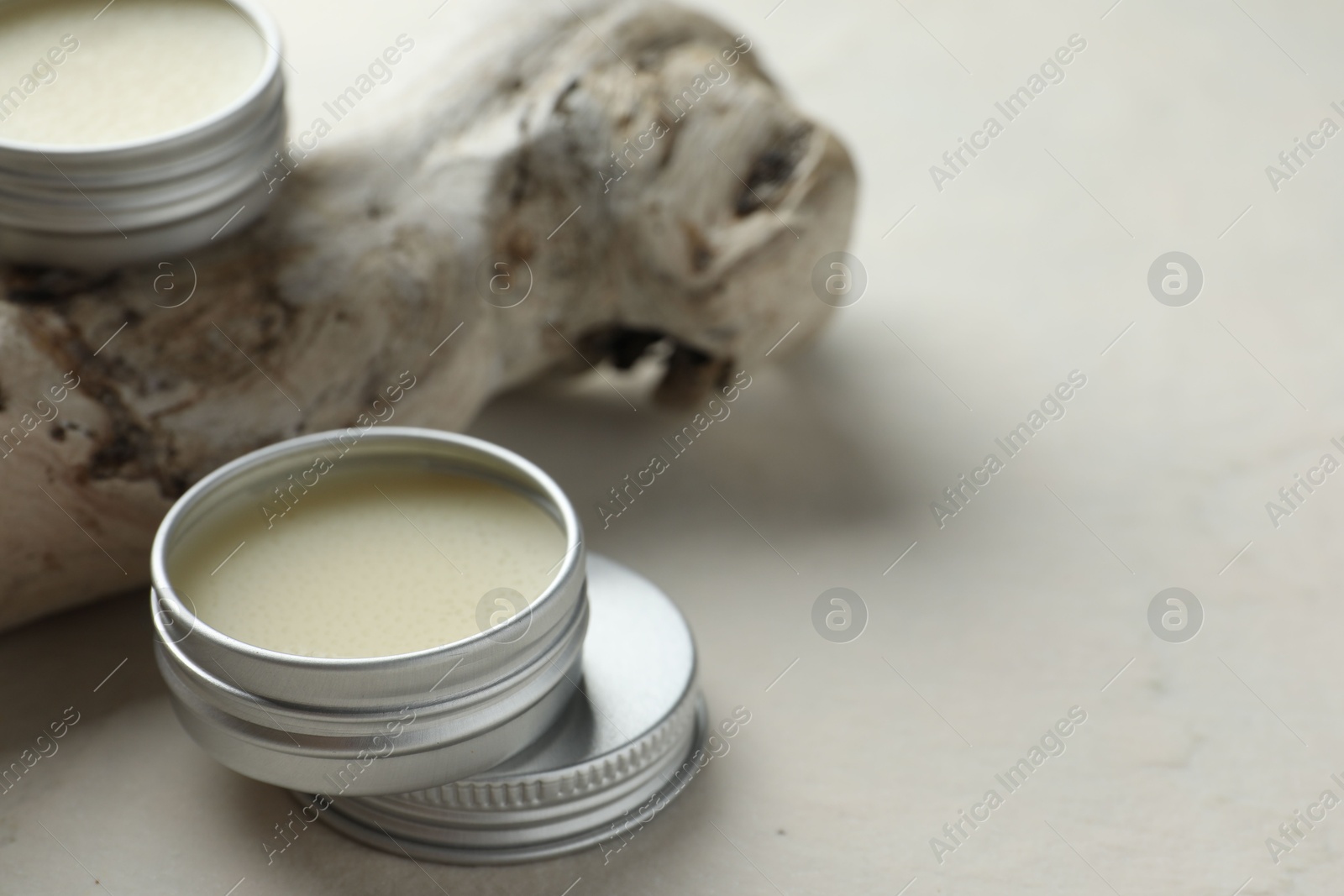 Photo of Natural solid perfume and snag on white background, closeup. Space for text