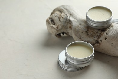 Photo of Natural solid perfume and snag on white background, closeup. Space for text