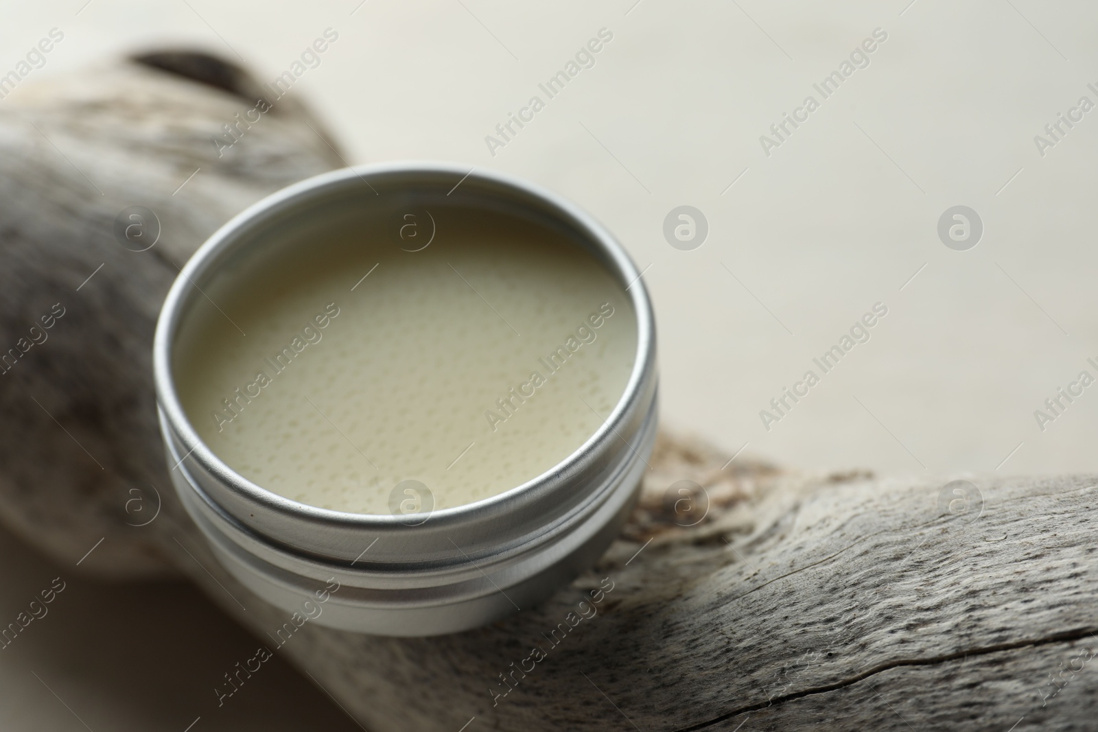 Photo of Natural solid perfume in container and snag on white table, closeup