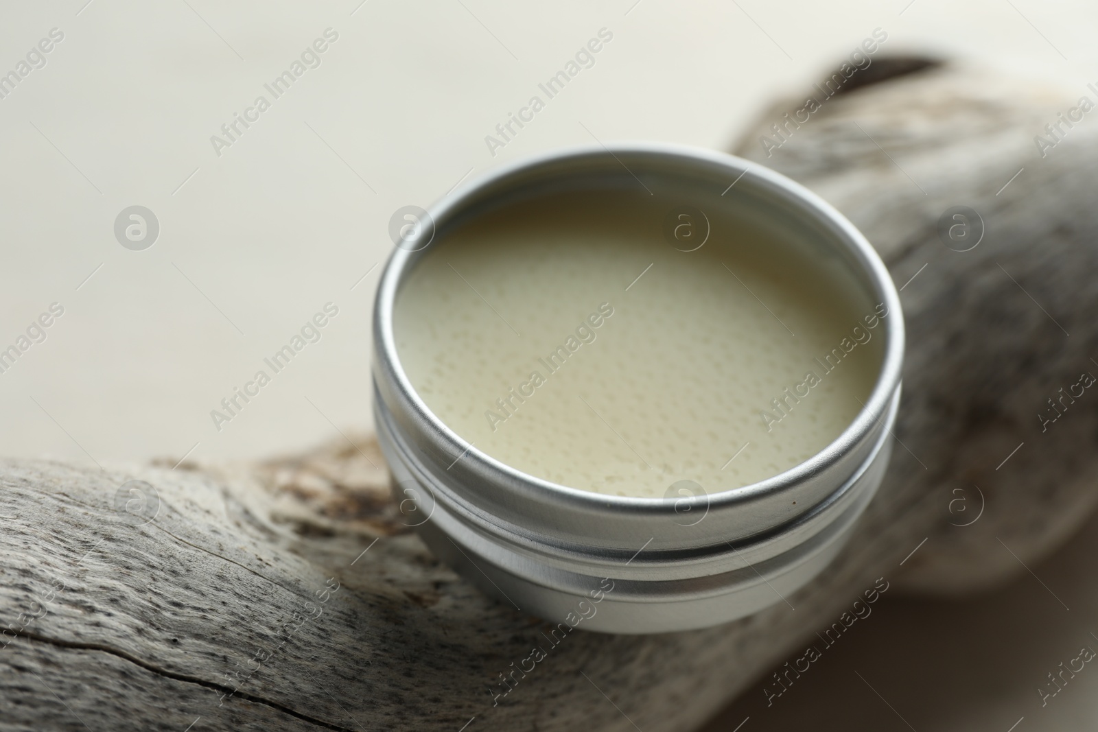 Photo of Natural solid perfume in container and snag on white table, closeup