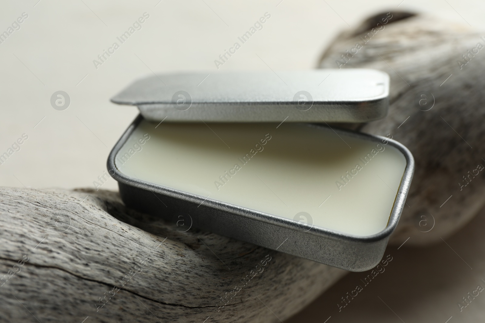 Photo of Natural solid perfume in container and snag on white table, closeup