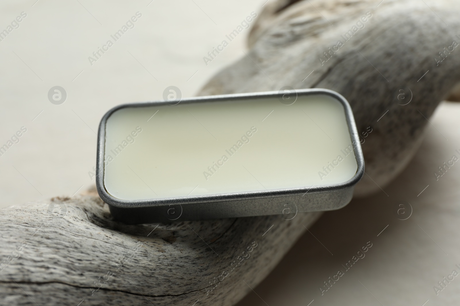 Photo of Natural solid perfume in container and snag on white table, closeup