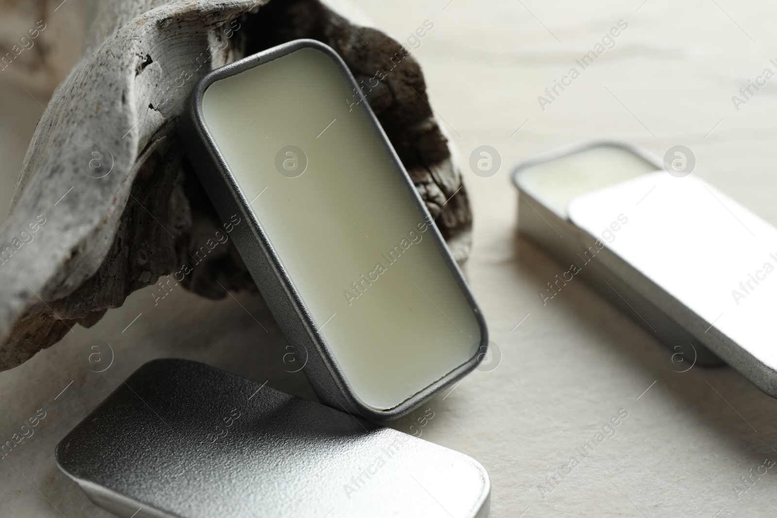 Photo of Natural solid perfume and snag on white table, closeup