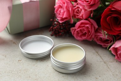 Photo of Natural solid perfume, gift box and flowers on light table