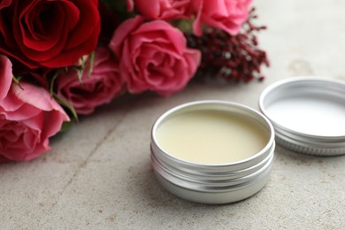 Photo of Natural solid perfume and flowers on light table, closeup