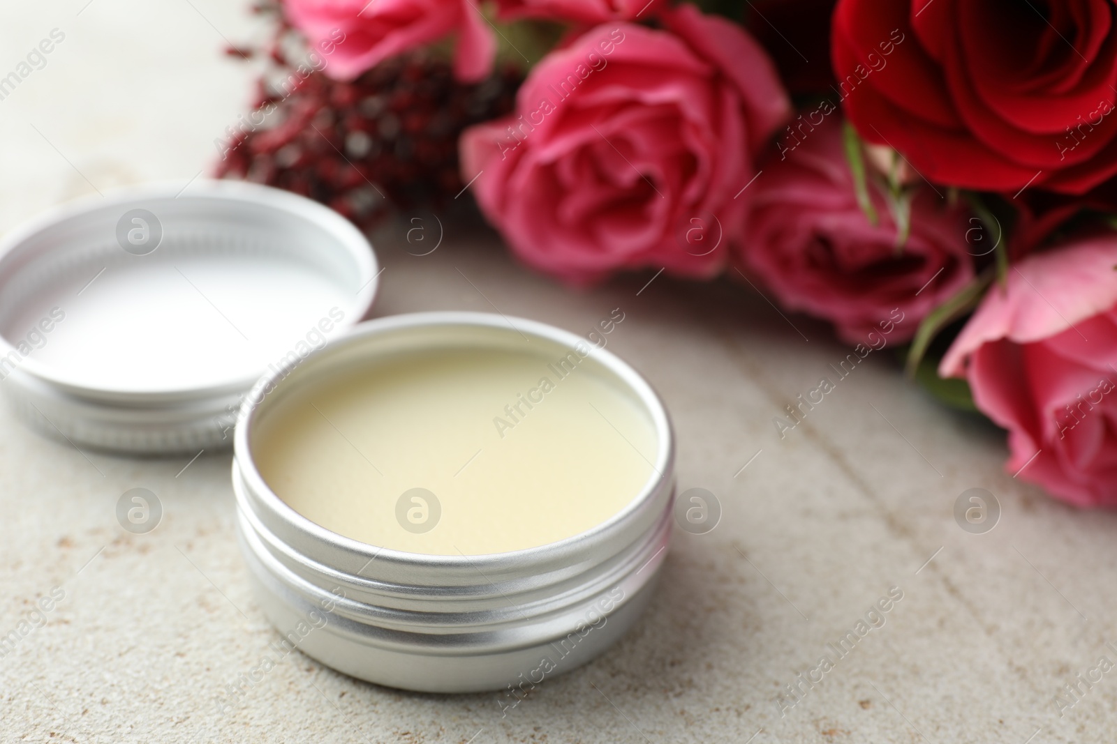 Photo of Natural solid perfume and flowers on light table, closeup