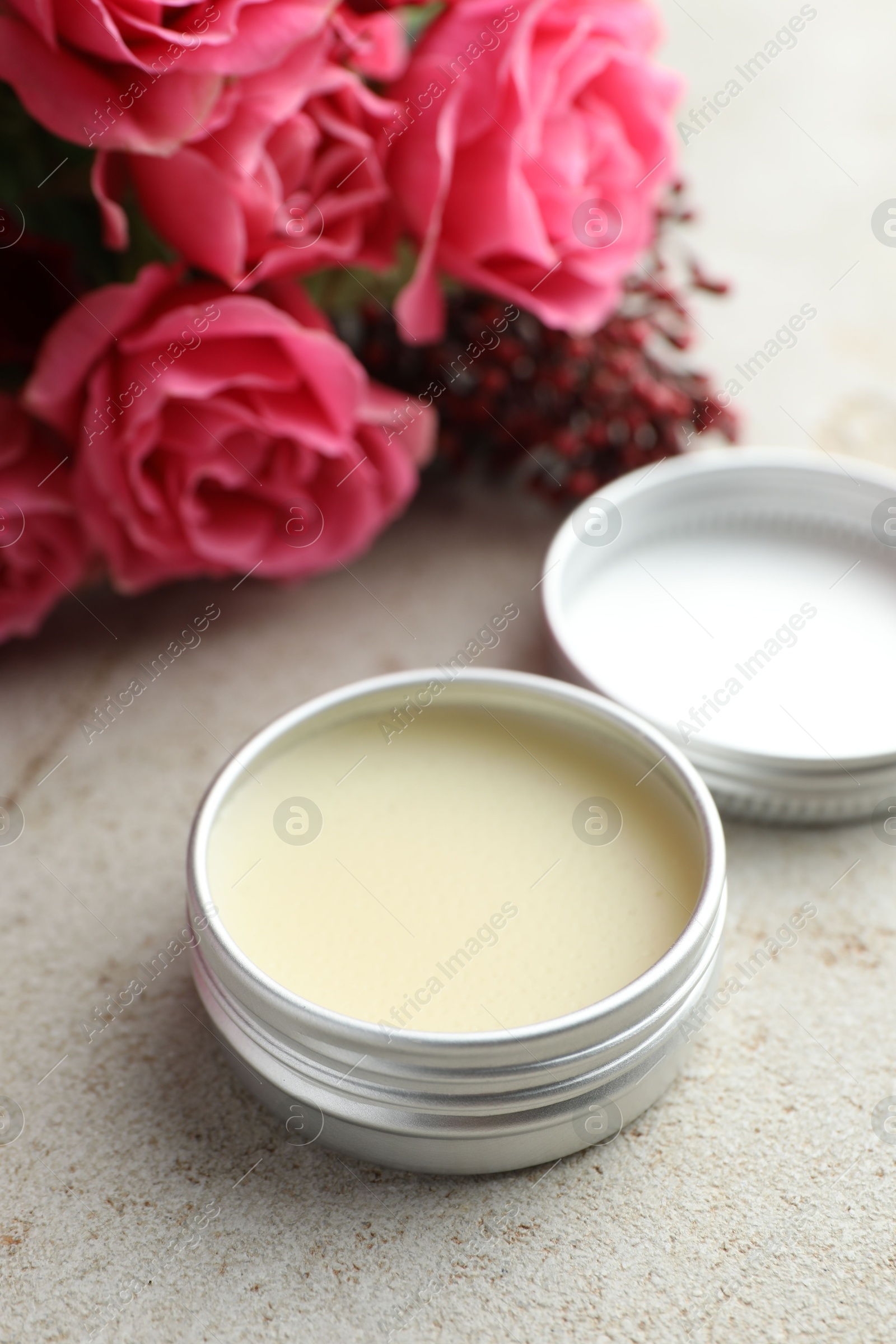 Photo of Natural solid perfume and flowers on light table, closeup