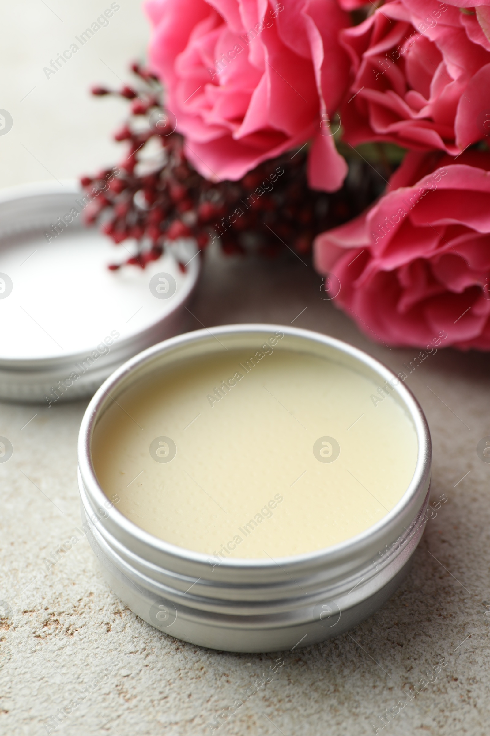 Photo of Natural solid perfume and flowers on light table, closeup