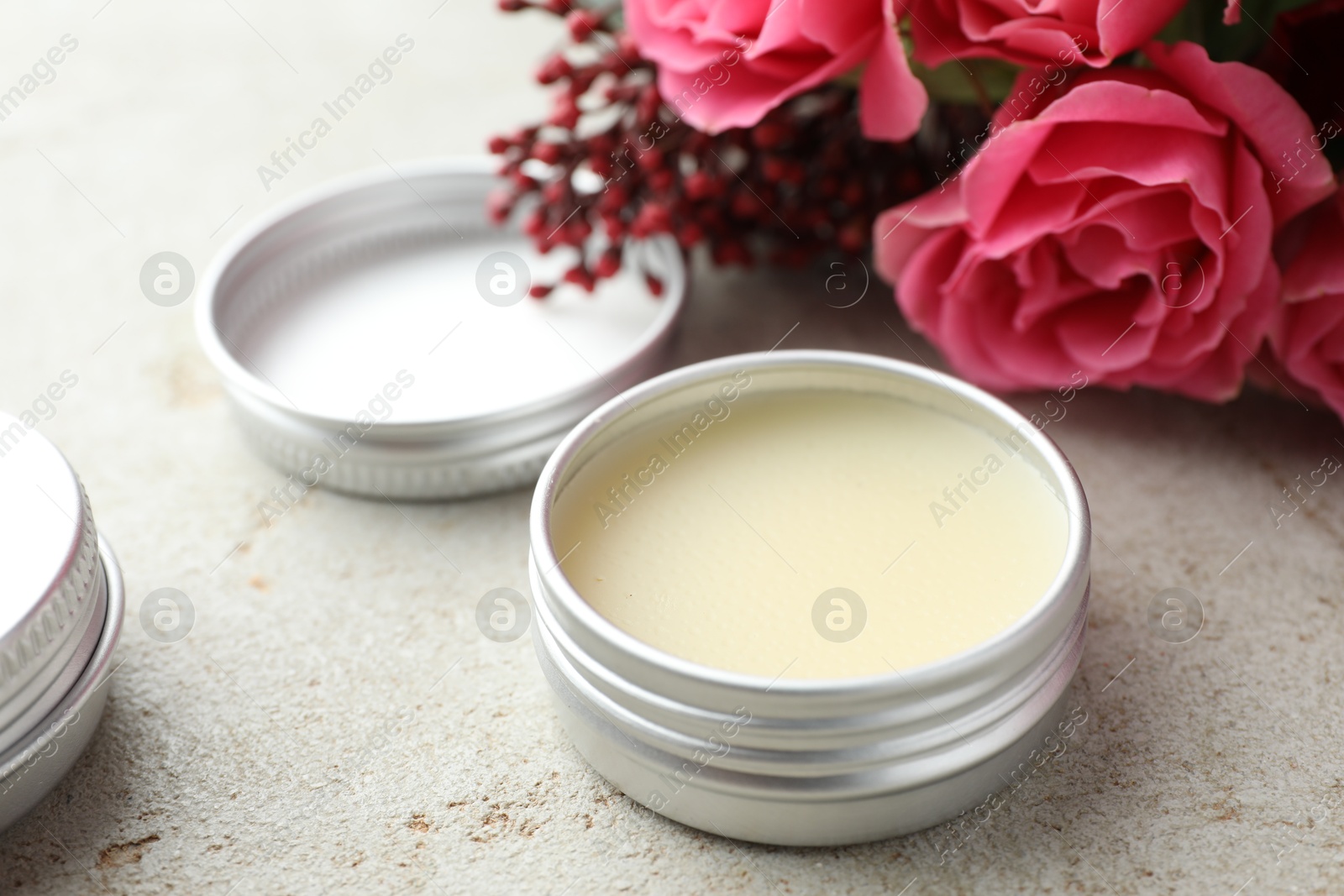 Photo of Natural solid perfume and flowers on light table, closeup