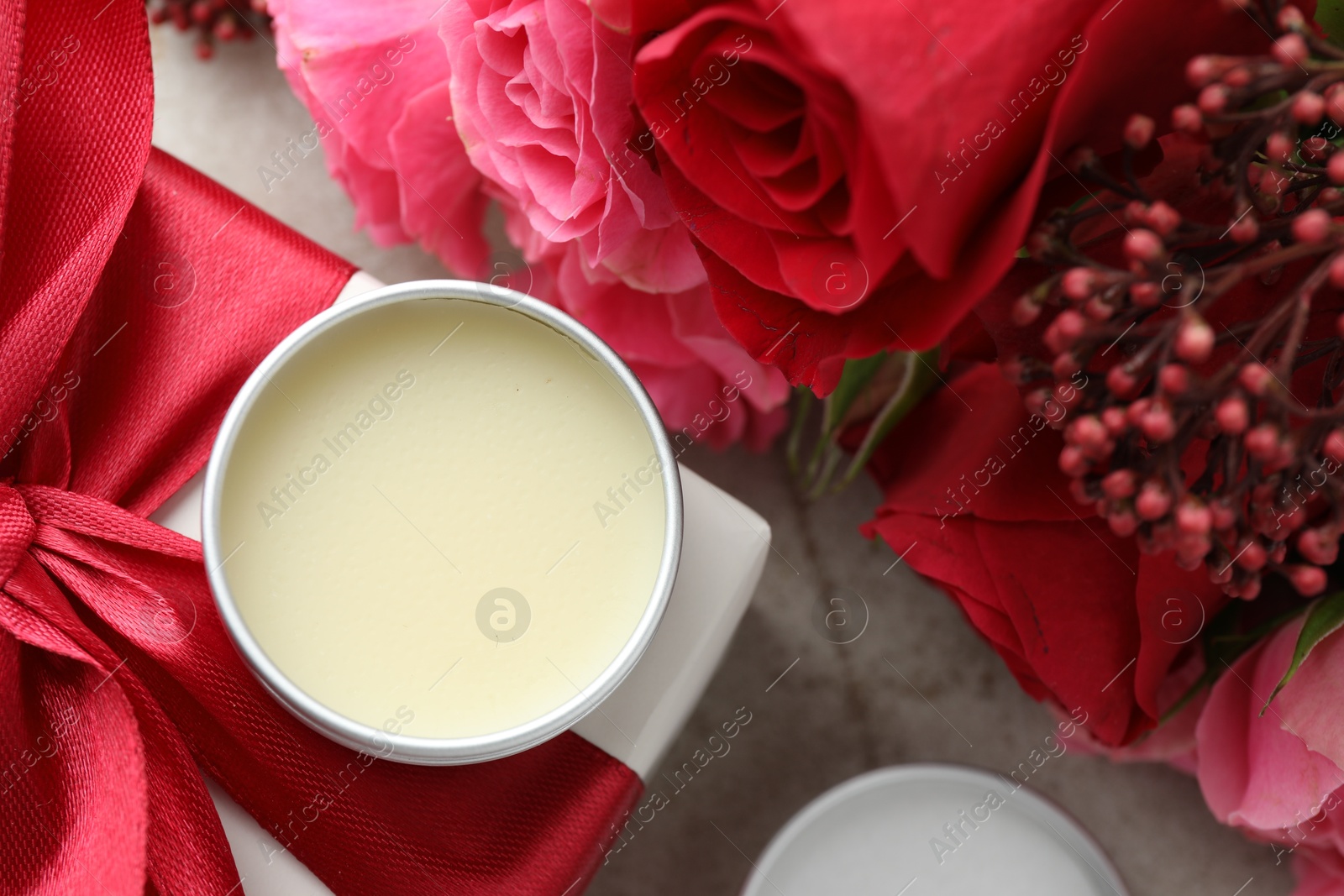 Photo of Natural solid perfume, gift box and flowers on light table, flat lay