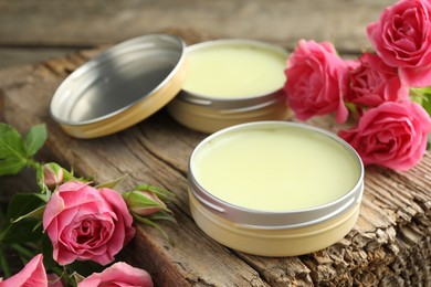 Photo of Natural solid perfume and pink roses on wood, closeup