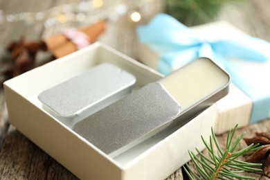 Photo of Natural solid perfume in gift box on wooden table, closeup