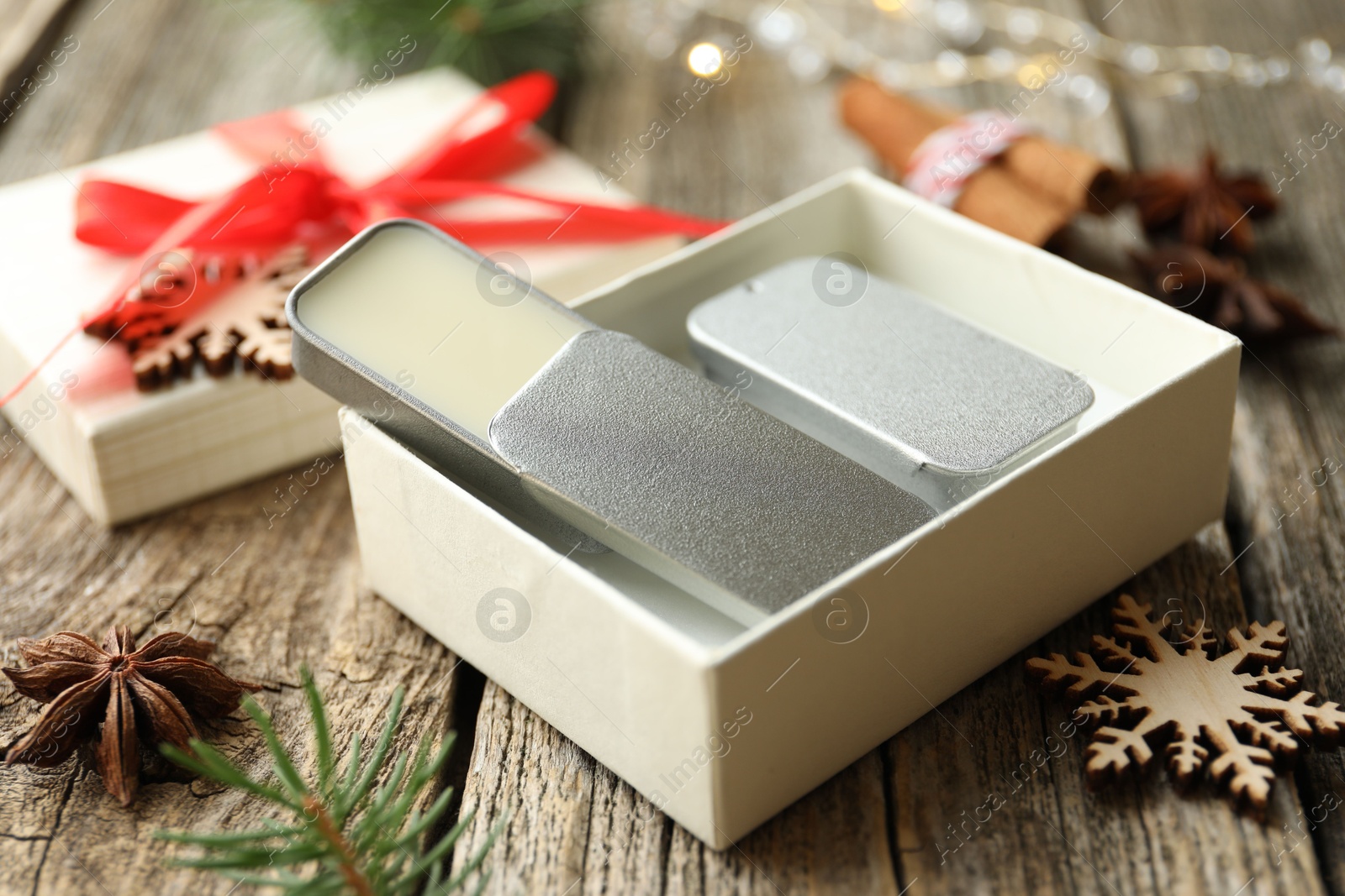 Photo of Natural solid perfume and Christmas decor on wooden table, closeup